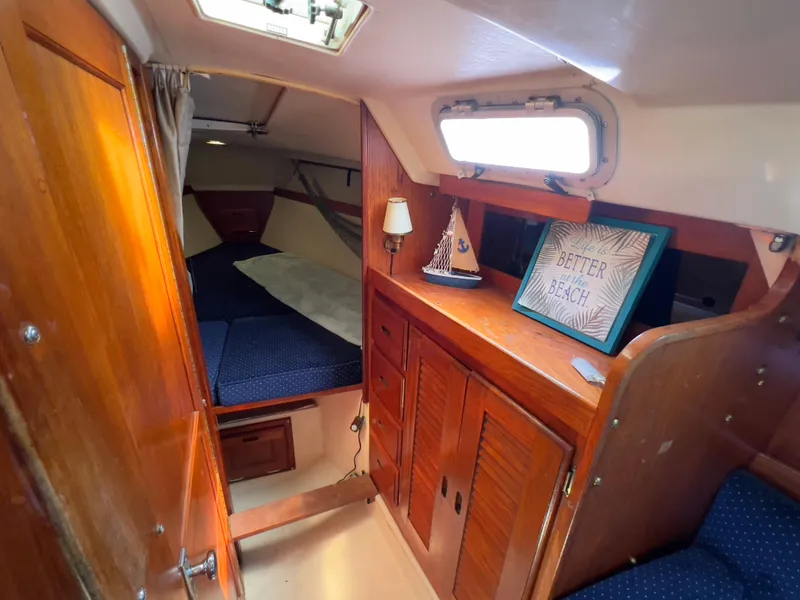Slide: The Image of Interior of 1986 Catalina 30 sailboat with cozy cabin and wooden furnishings. - 25