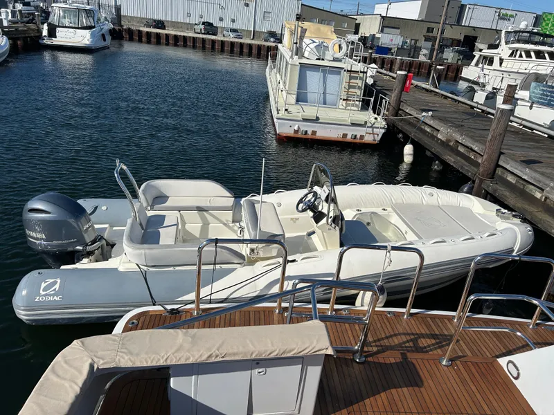 Slide: The Image of Zodiac N-Z0 680 boat, 2020 model, docked at a marina with other vessels. - 3