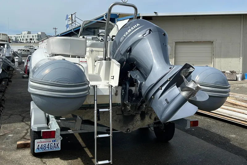 Slide: The Image of 2020 Zodiac N-Z0 680 inflatable boat with Yamaha outboard motor, parked on a trailer. - 7