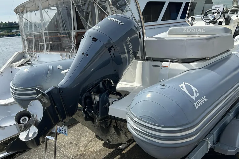Slide: The Image of 2020 Zodiac N-Z0 680 inflatable boat with outboard motor docked at marina. - 8