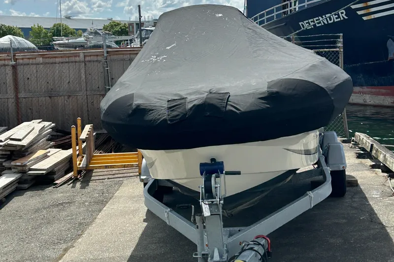 Slide: The Image of Covered Zodiac N-Z0 680 boat on trailer, docked outdoors, 2020 model. - 9