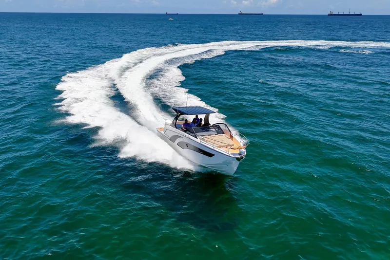 Slide: The Image of 2025 Hanover 347 Outboard boat cruising on open sea, leaving a wake trail. - 2