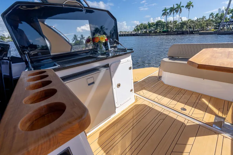 Slide: The Image of Luxurious 2025 Hanover 347 Outboard boat interior with wooden deck and seating area. - 9