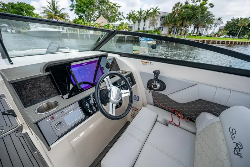 Slide: The Image of 2022 Sea Ray SDX 290 boat interior with modern dashboard and steering wheel. - 12