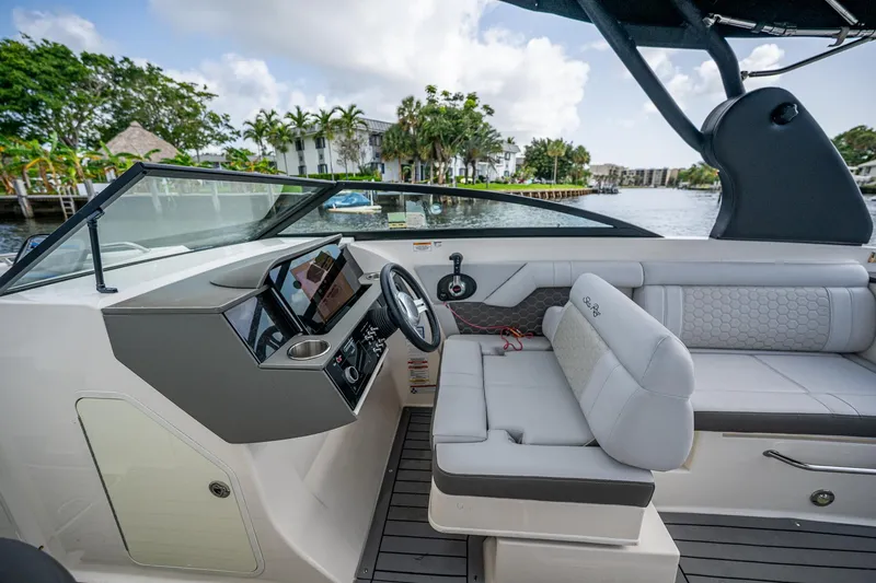 Slide: The Image of 2022 Sea Ray SDX 290 boat interior with modern helm and seating. - 13