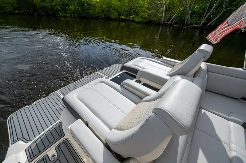 Slide: The Image of 2022 Sea Ray SDX 290 boat with luxurious seating on a calm river. - 20
