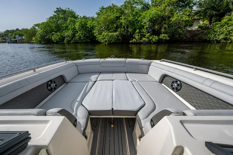 Slide: The Image of 2022 Sea Ray SDX 290 boat interior with spacious seating and scenic water view. - 31