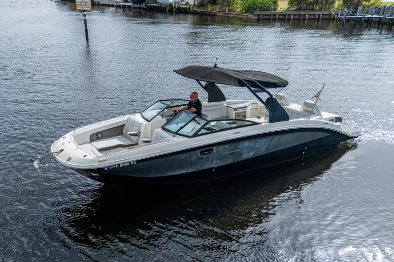 Slide: The Image of 2022 Sea Ray SDX 290 boat cruising on a calm river with a canopy. - 38