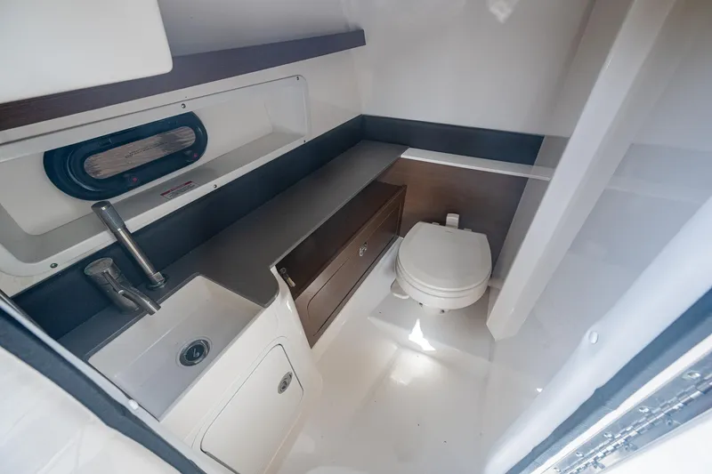 Slide: The Image of 2022 Sea Ray SDX 290 boat interior bathroom with sink and toilet. - 7