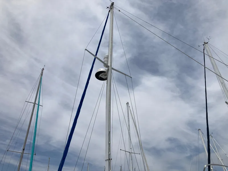 Slide: The Image of Masts of a 1963 Sumnercraft 31 Motor Sailer against a cloudy sky. - 13