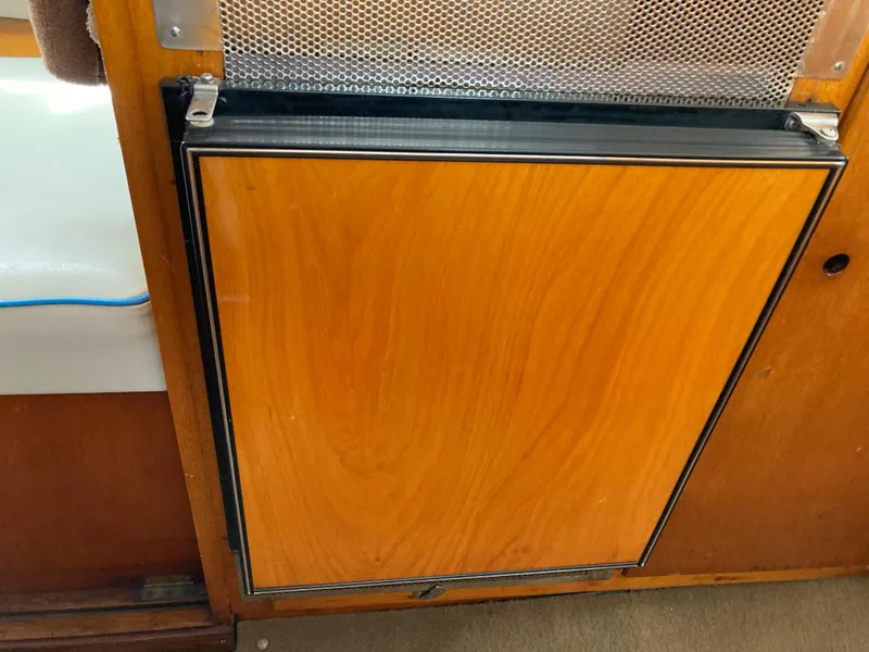 Slide: The Image of Wooden cabinet door on a 1963 Sumnercraft 31 Motor Sailer interior. - 18