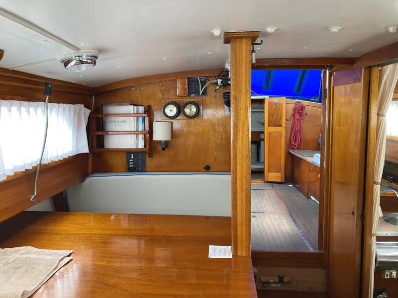 Slide: The Image of Interior of a 1963 Sumnercraft 31 Motor Sailer with wooden furnishings and nautical decor. - 19