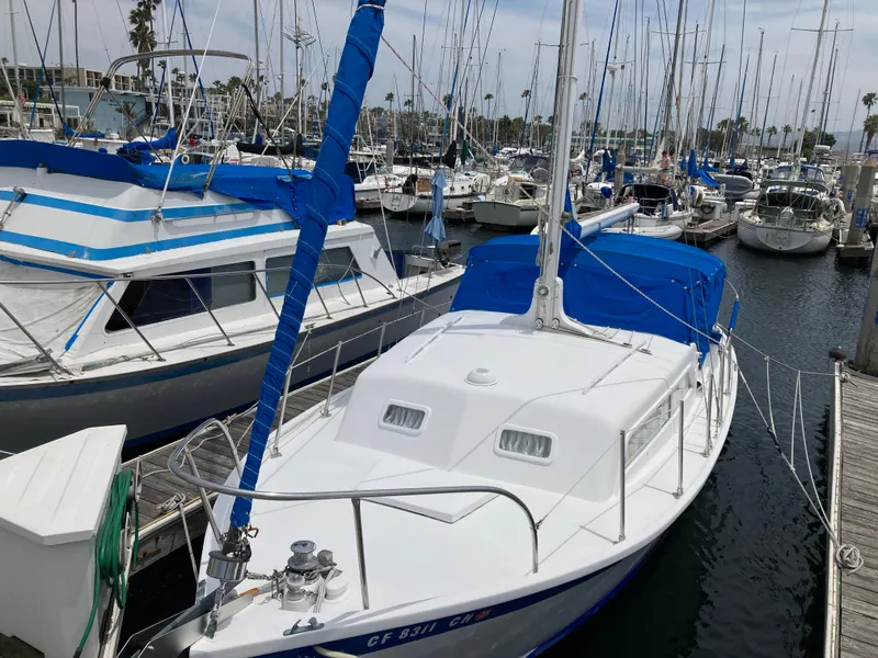 Slide: The Image of 1963 Sumnercraft 31 Motor Sailer docked in a marina with other boats. - 2