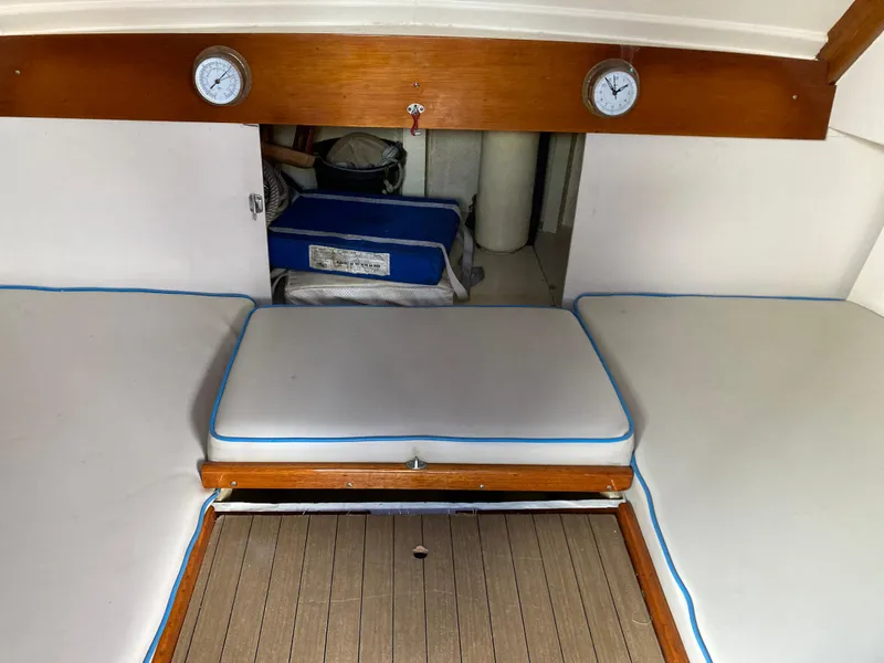 Slide: The Image of Interior of a 1963 Sumnercraft 31 Motor Sailer with cushioned seating and wooden accents. - 26