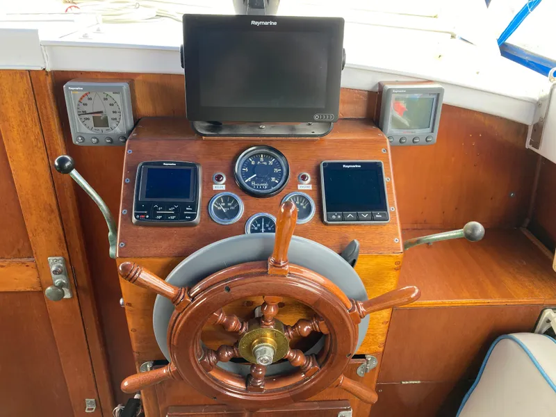 Slide: The Image of Helm of 1963 Sumnercraft 31 Motor Sailer with wooden wheel and navigation instruments. - 29