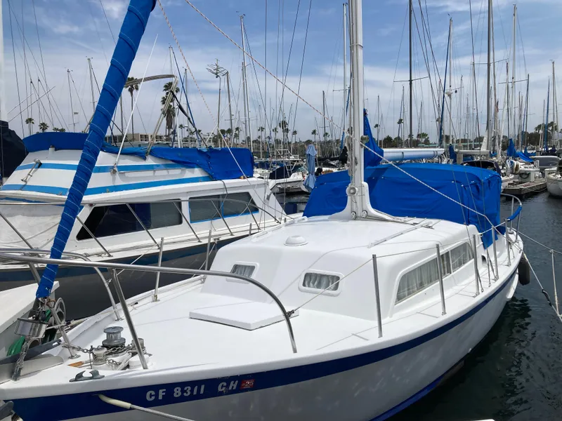 Slide: The Image of 1963 Sumnercraft 31 Motor Sailer docked in a marina, surrounded by other boats. - 3