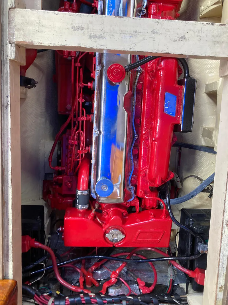 Slide: The Image of Engine compartment of a 1963 Sumnercraft 31 Motor Sailer, featuring a vibrant red engine. - 31