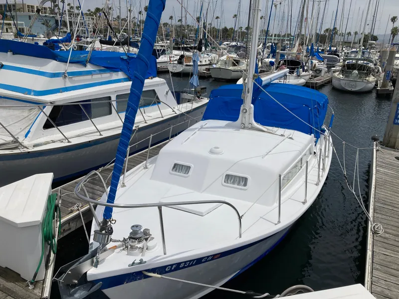 Slide: The Image of 1963 Sumnercraft 31 Motor Sailer docked in a marina, featuring blue accents and white hull. - 4