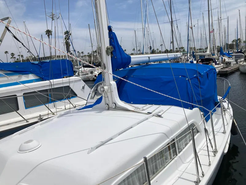 Slide: The Image of 1963 Sumnercraft 31 Motor Sailer with blue cover docked in marina. - 5