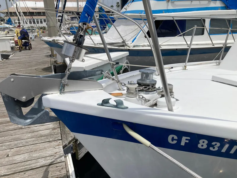 Slide: The Image of 1963 Sumnercraft 31 Motor Sailer docked, showcasing anchor and deck equipment. - 6