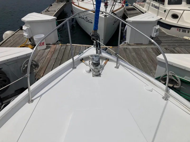 Slide: The Image of Bow view of 1963 Sumnercraft 31 Motor Sailer docked at marina. - 7