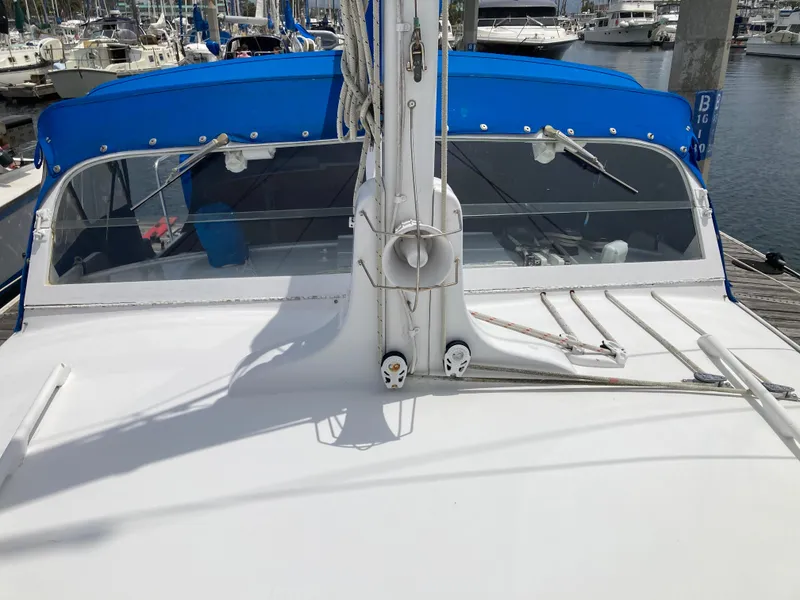 Slide: The Image of 1963 Sumnercraft 31 Motor Sailer with blue canopy docked at marina. - 8