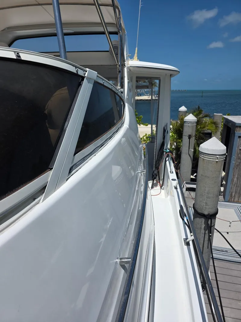 Slide: The Image of 2000 Carver 396 Motor Yacht docked, showcasing sleek design and ocean view. - 12
