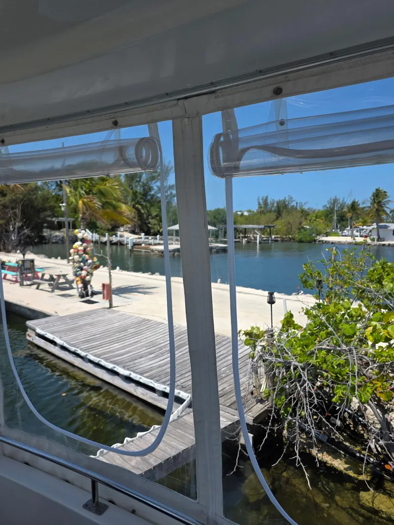 Slide: The Image of View from 2000 Carver 396 Motor Yacht window overlooking dock and serene waterfront. - 14