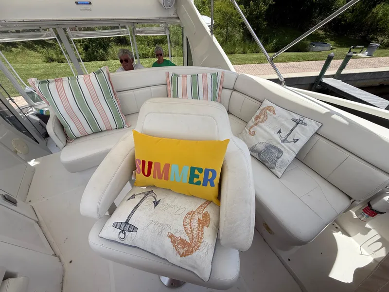 Slide: The Image of 2001 Carver 396 Motor Yacht interior with decorative pillows and seating area. - 18