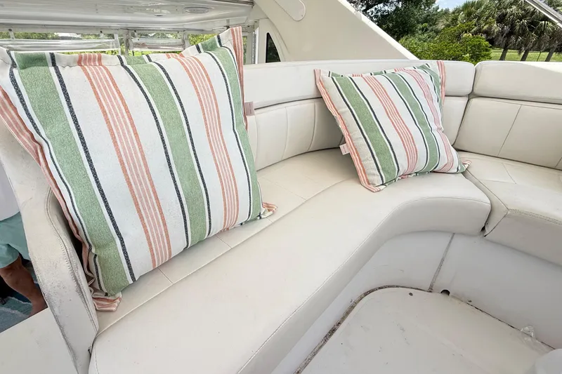 Slide: The Image of 2001 Carver 396 Motor Yacht interior with striped cushions on white seating. - 19