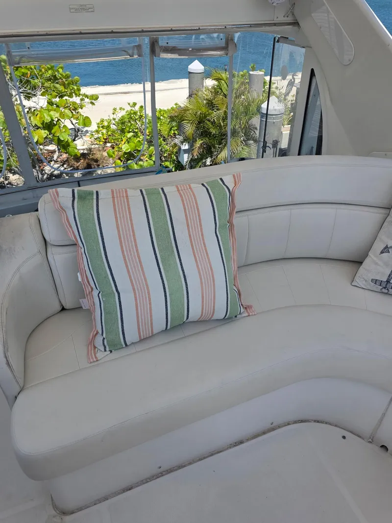 Slide: The Image of 2000 Carver 396 Motor Yacht interior with striped cushion, ocean view in background. - 20
