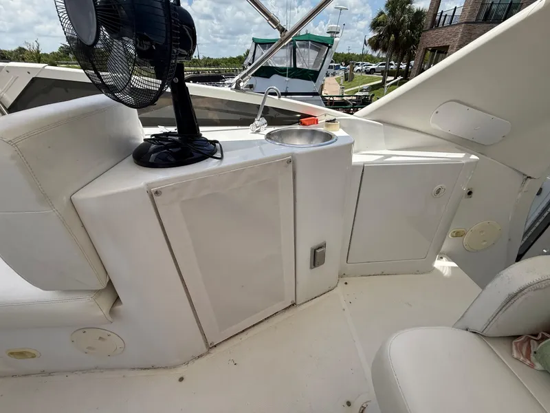 Slide: The Image of 2001 Carver 396 Motor Yacht interior with seating, fan, and sink. - 22