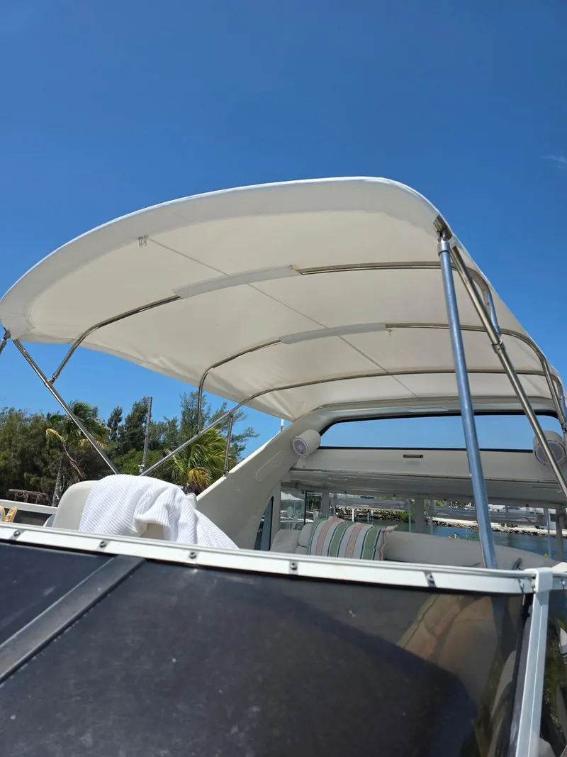 Slide: The Image of 2000 Carver 396 Motor Yacht with canopy under clear blue sky. - 23