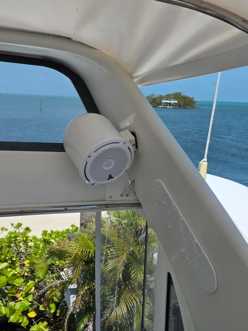 Slide: The Image of 2000 Carver 396 Motor Yacht interior with speaker, ocean view, and lush greenery. - 24