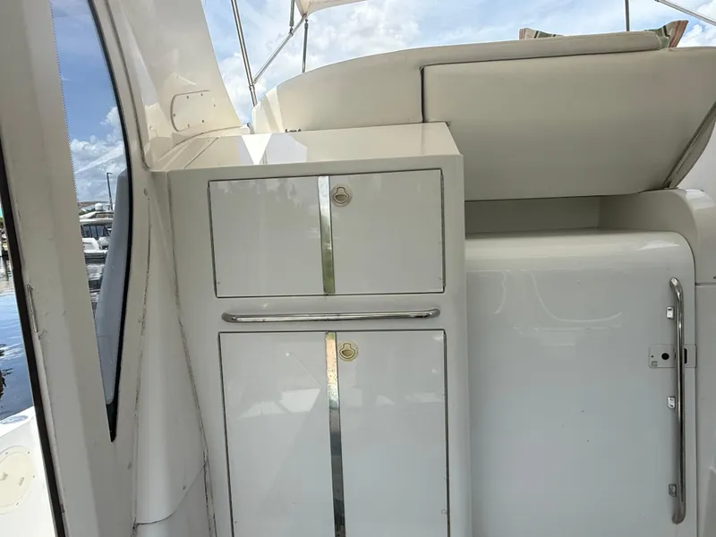 Slide: The Image of 2001 Carver 396 Motor Yacht interior with white cabinetry and chrome accents. - 26
