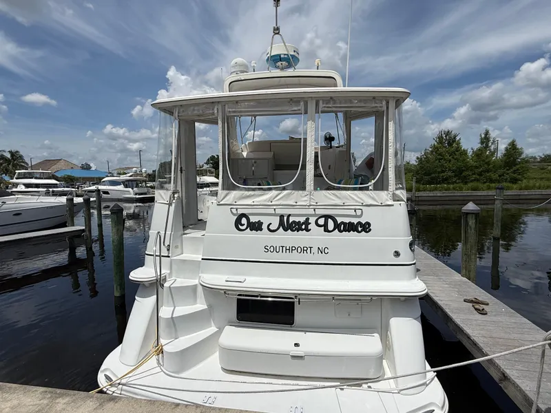 Slide: The Image of 2001 Carver 396 Motor Yacht docked, named "Our Next Dance," in Southport, NC marina. - 3