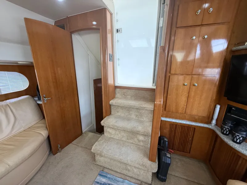 Slide: The Image of Interior of 2001 Carver 396 Motor Yacht with wooden cabinetry and carpeted stairs. - 30