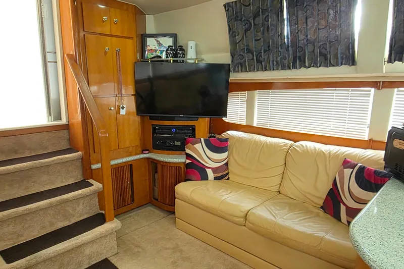 Slide: The Image of Interior of 2001 Carver 396 Motor Yacht with beige sofa and entertainment center. - 31