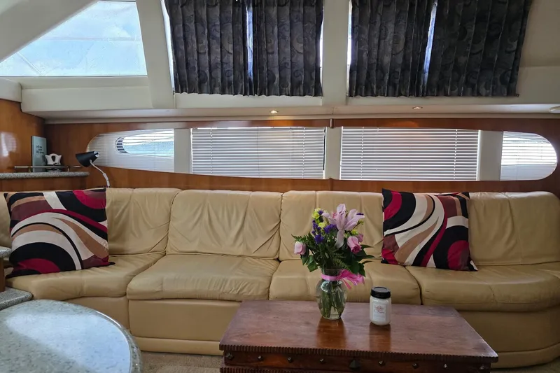 Slide: The Image of Luxurious interior of 2001 Carver 396 Motor Yacht with beige sofa and floral decor. - 37