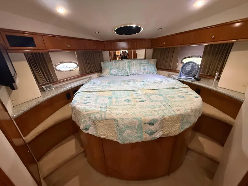 Slide: The Image of Luxurious bedroom interior of 2001 Carver 396 Motor Yacht with cozy bedding and elegant wood finish. - 43