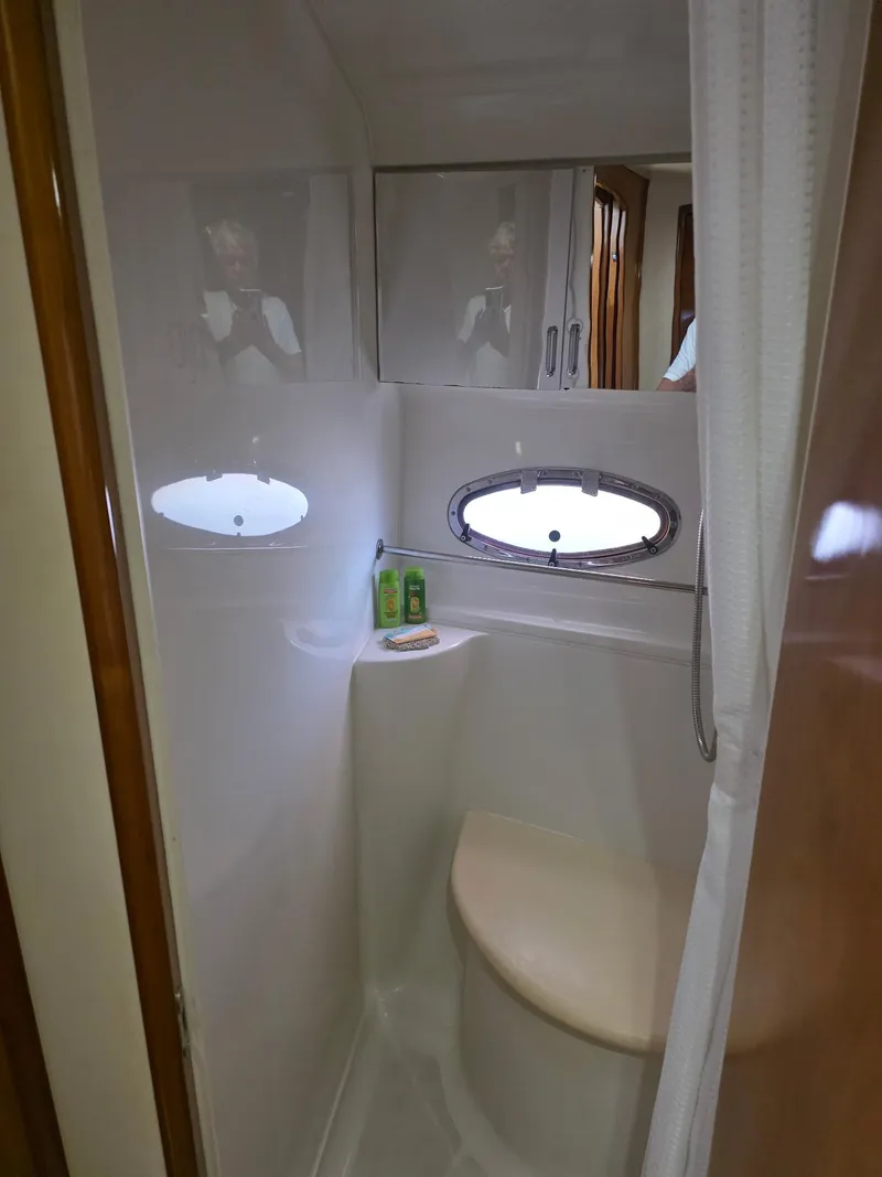 Slide: The Image of 2000 Carver 396 Motor Yacht bathroom with porthole and storage cabinets. - 50
