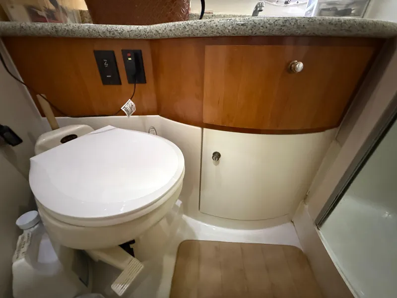Slide: The Image of Bathroom interior of 2001 Carver 396 Motor Yacht with toilet and wooden cabinetry. - 51