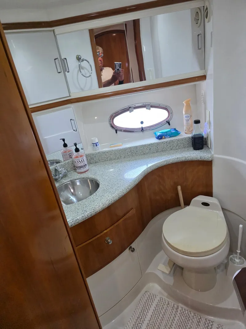Slide: The Image of Bathroom interior of 2000 Carver 396 Motor Yacht with sink, toilet, and storage cabinets. - 53
