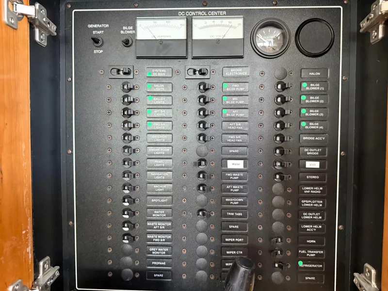 Slide: The Image of Control panel of a 2001 Carver 396 Motor Yacht, featuring various switches and gauges. - 57