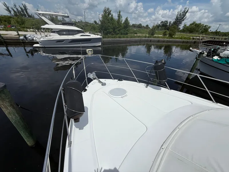 Slide: The Image of 2001 Carver 396 Motor Yacht docked in a marina, with clear skies and calm water. - 8