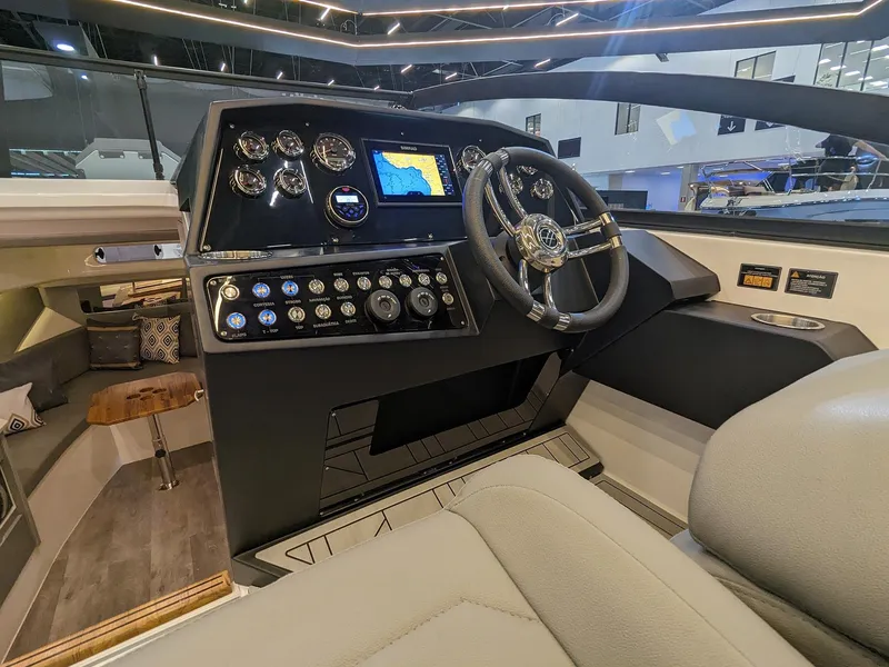 Slide: The Image of 2025 Hanover 347 Inboard boat cockpit with modern controls and navigation display. - 11