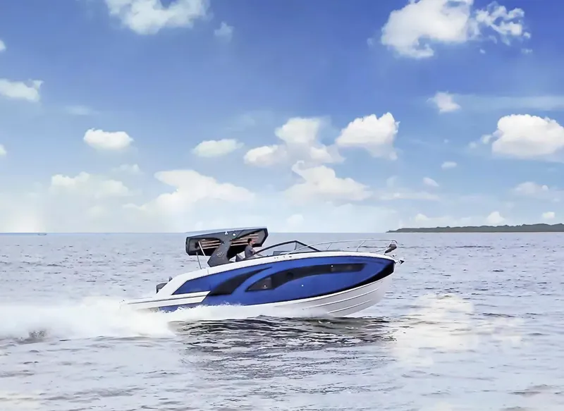 Slide: The Image of 2025 Hanover 347 Inboard boat cruising on open water under a clear blue sky. - 2
