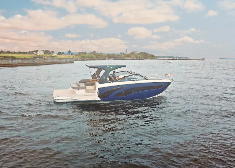 Slide: The Image of 2025 Hanover 347 Inboard boat cruising on a calm lake under a partly cloudy sky. - 4