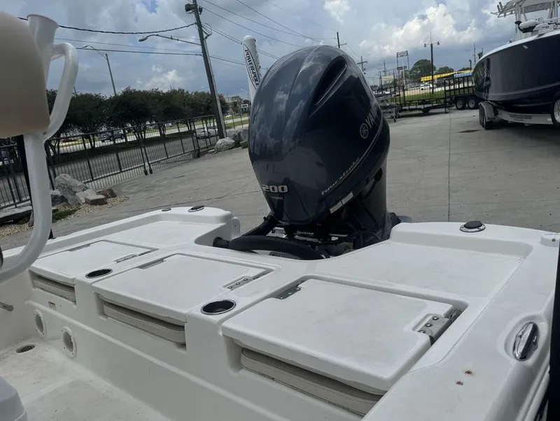 Slide: The Image of Rear view of a 2022 NauticStar 215 Bay boat outdoors. - 12