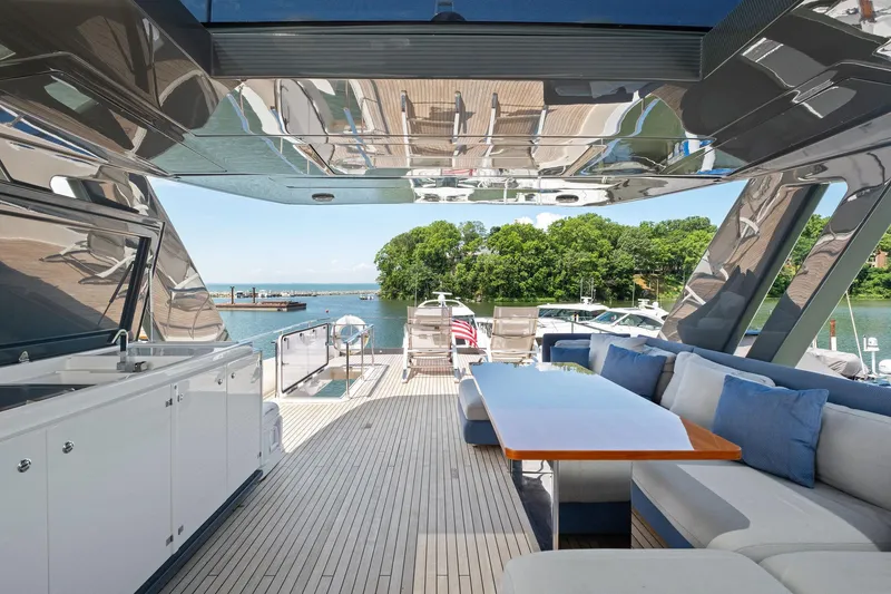 Slide: The Image of Luxurious 2018 Ferretti Yachts 780 deck with elegant seating and scenic waterfront view. - 12